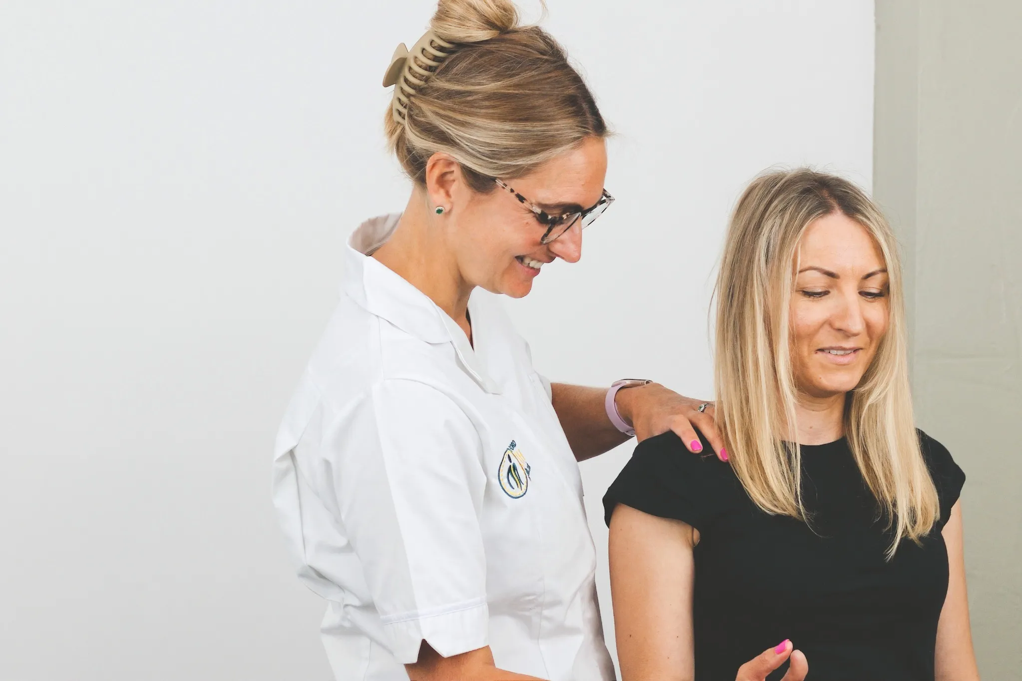 Osteopath carrying out a shoulder assessment during a first appointment