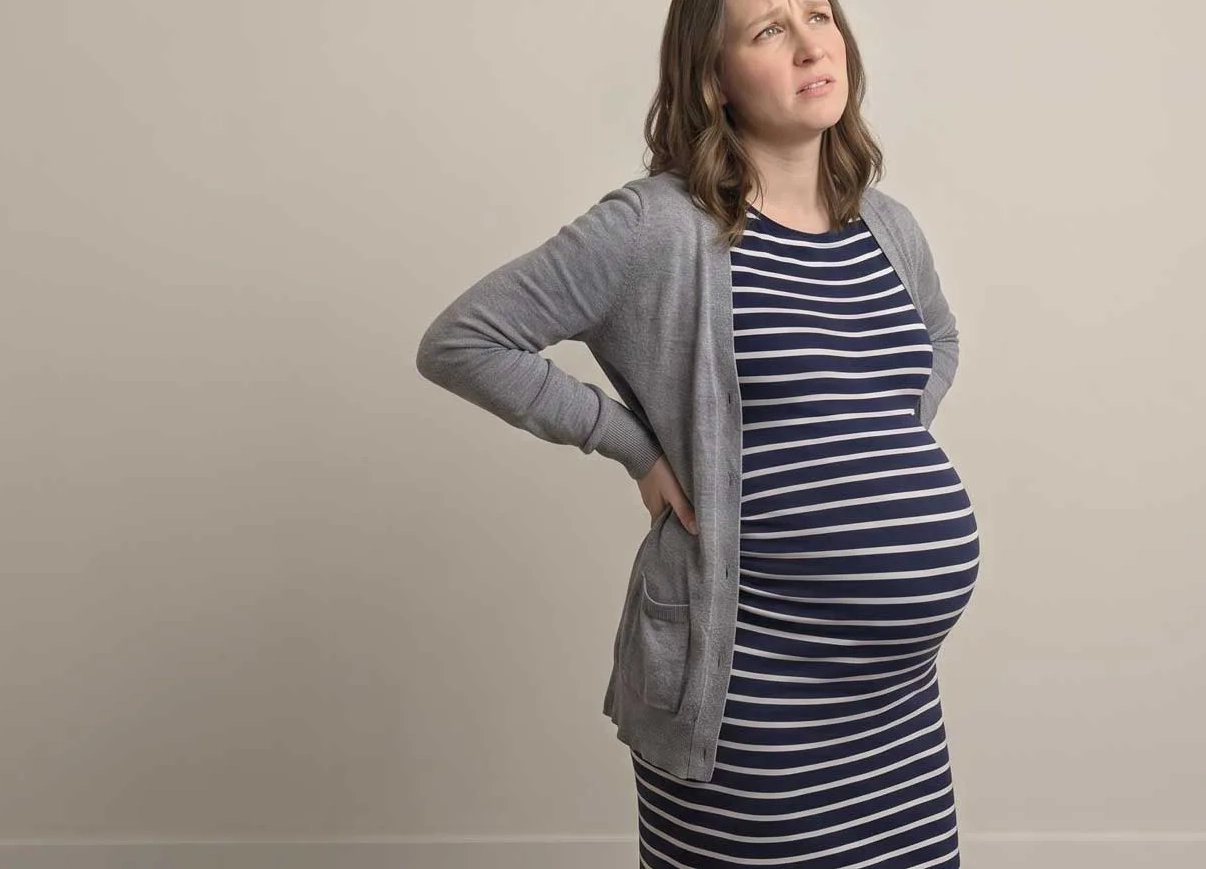 A pregnant woman experiencing lower back pain