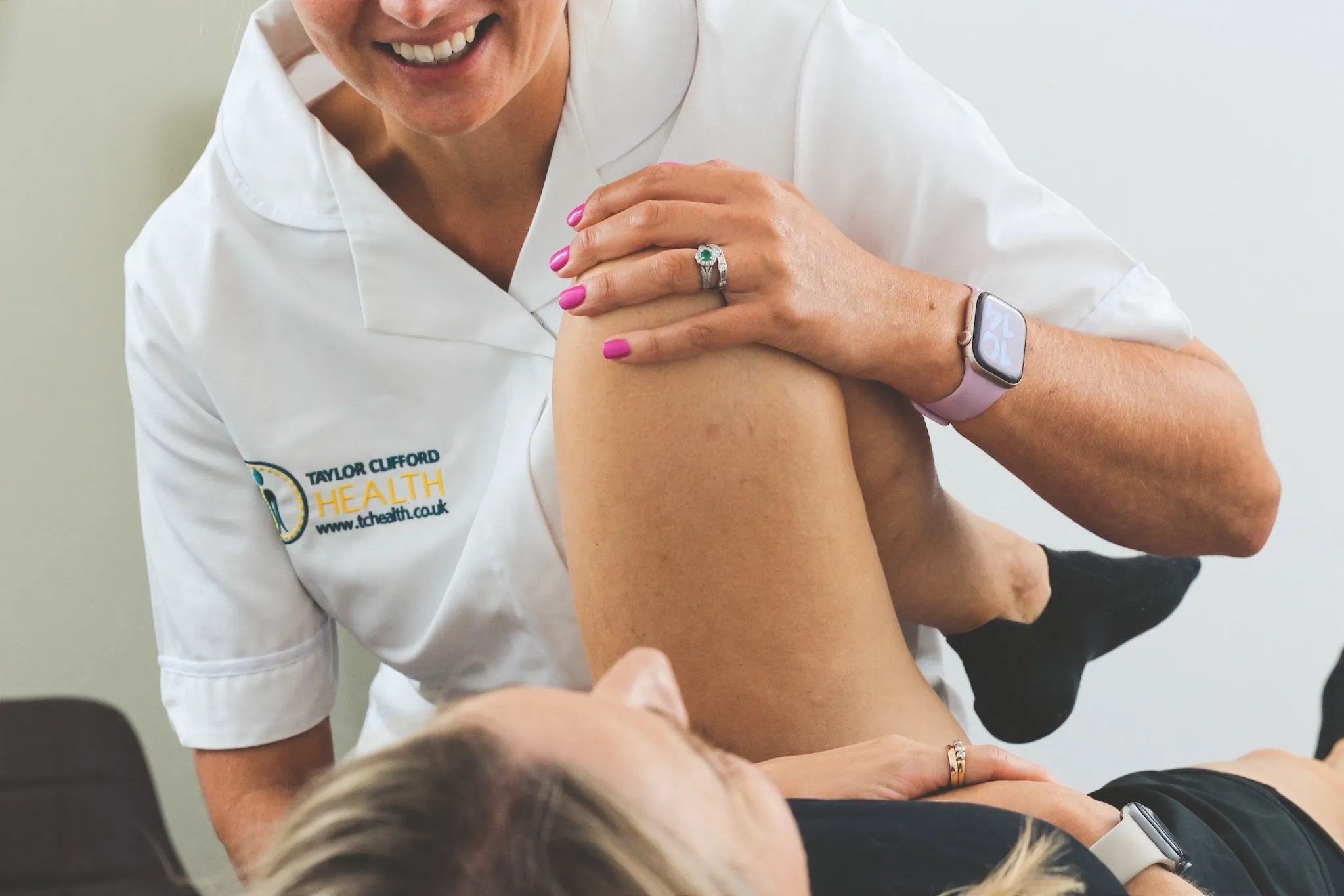Osteopath assessing hip and leg movement as part of sciatica treatment