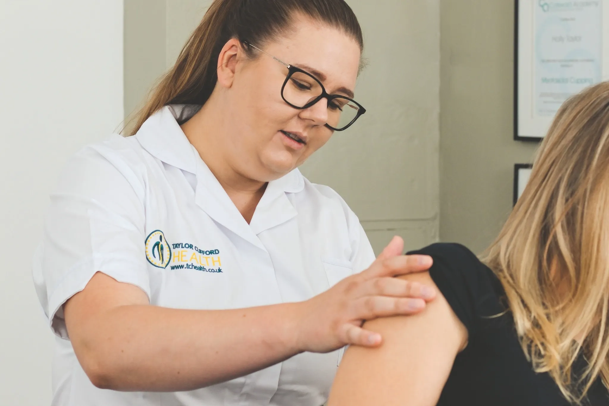 Osteopath assessing posture and shoulder position